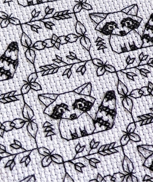 Close up of raccoon blackwork pattern stitched
