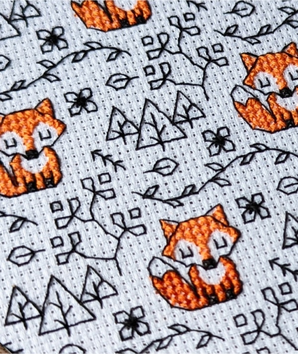 Close up of sleeping fox cross stitch blackwork pattern stitched