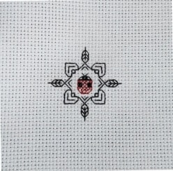 Stitched blackwork ladybug initial design