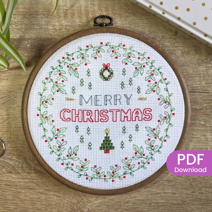 Stitched Christmas blackwork pattern with cross stitch xmas tree and Holly border