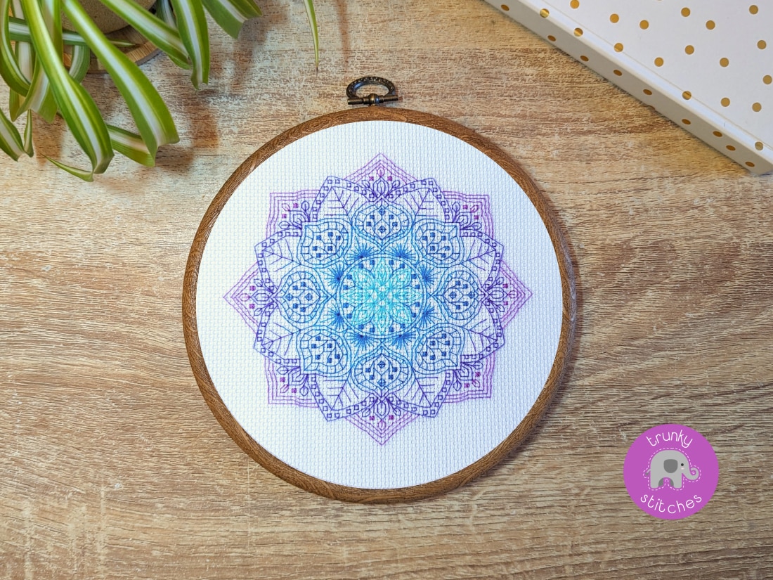 Framed blackwork embroidery piece of the Purple flower blackwork mandala pattern